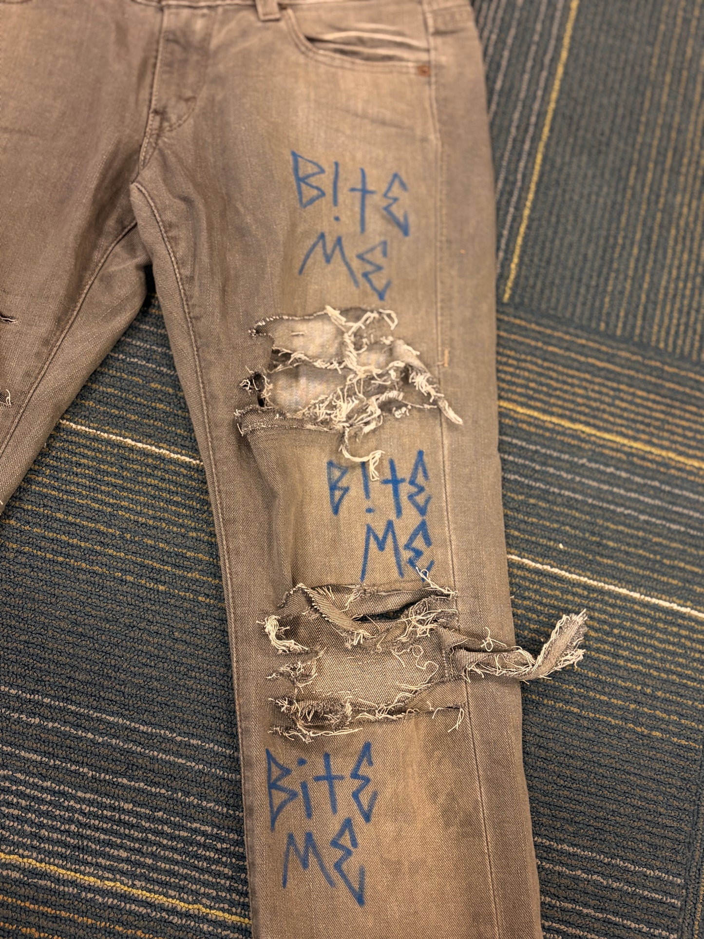 "Bite Me' Distressed Skinny Jeans