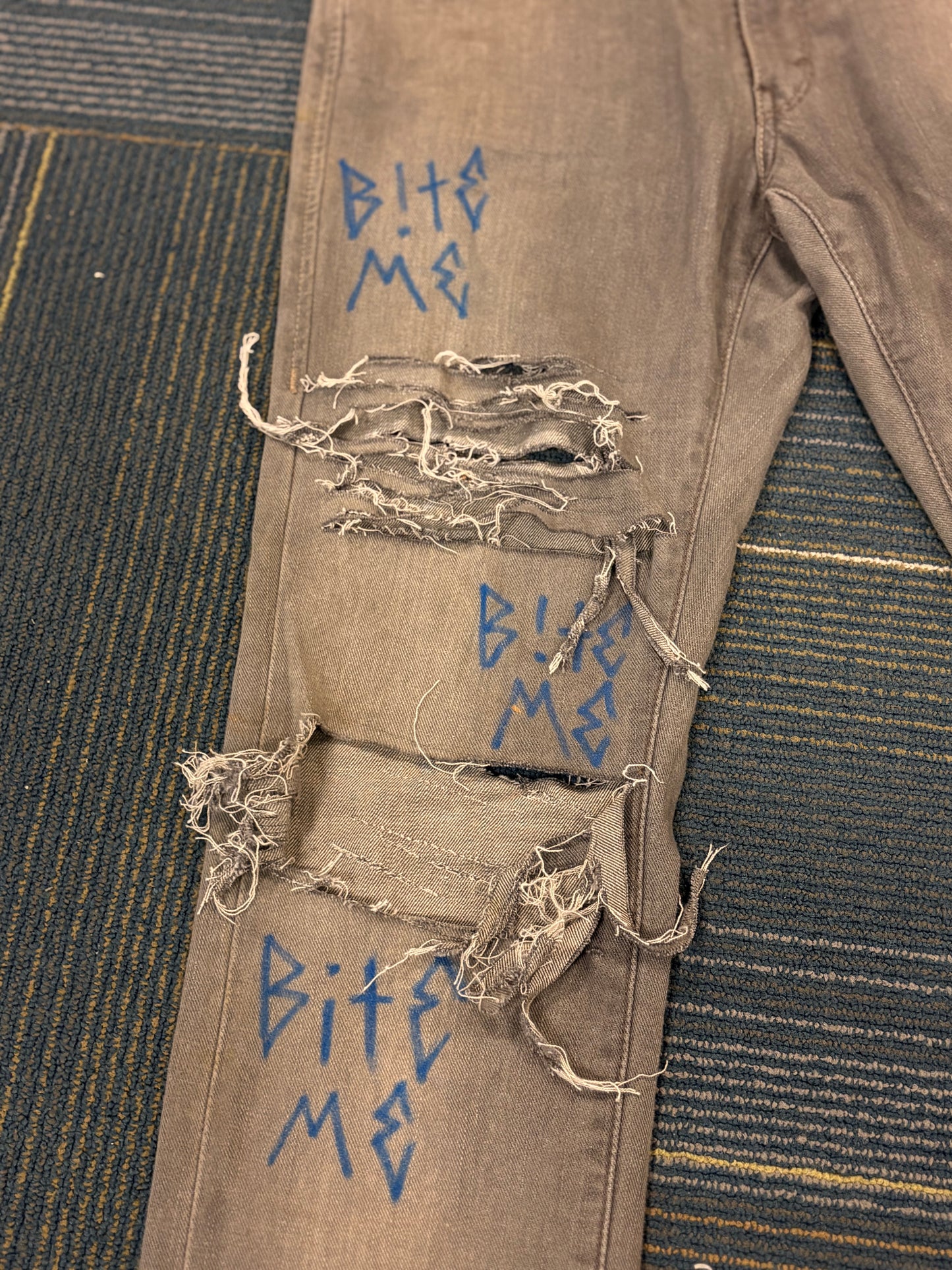 "Bite Me' Distressed Skinny Jeans