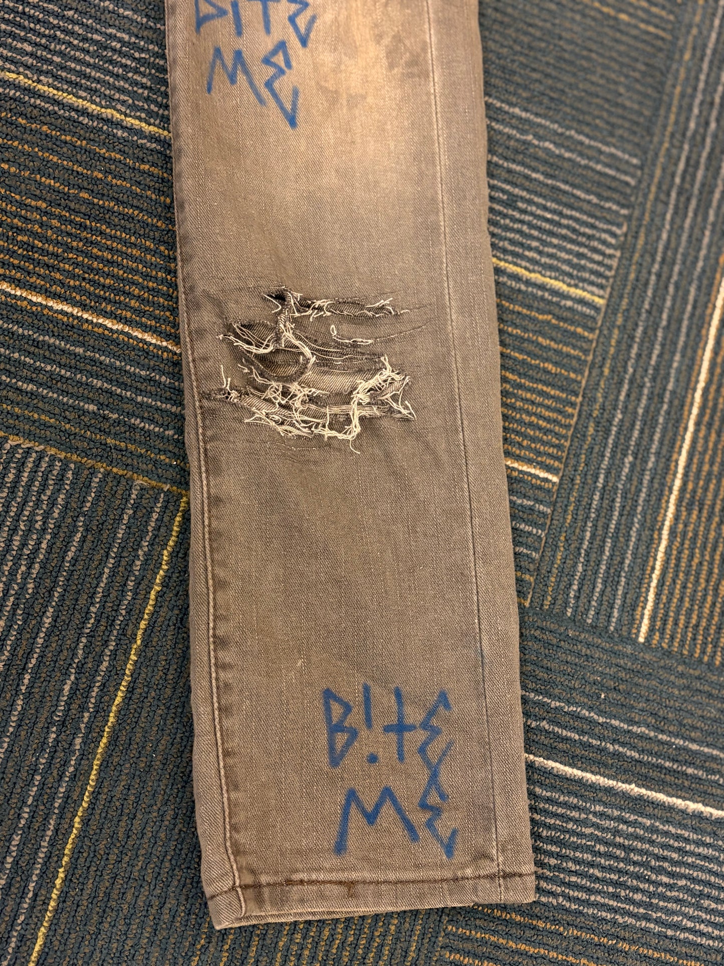 "Bite Me' Distressed Skinny Jeans